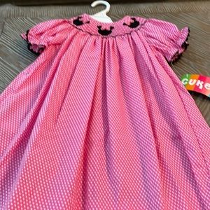 Pink and white Polk a dot mini mouse dress. Smocked